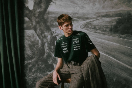 Green Aston Martin shirt worn with pants by model.