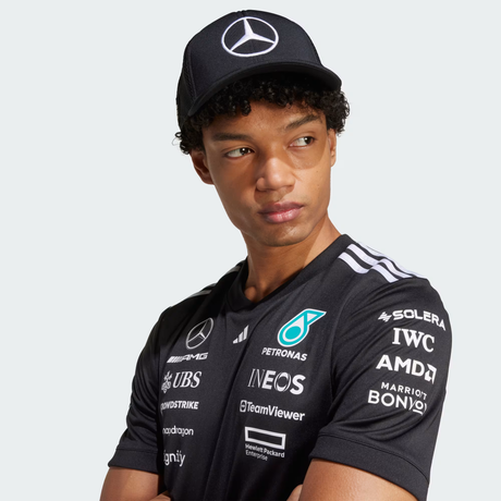 Person wearing black cap and team shirt.