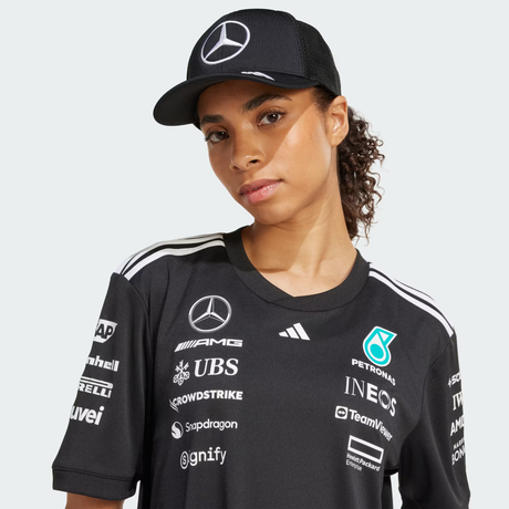 Person wearing black cap with team shirt.