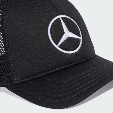 Close-up of black cap with Mercedes logo.