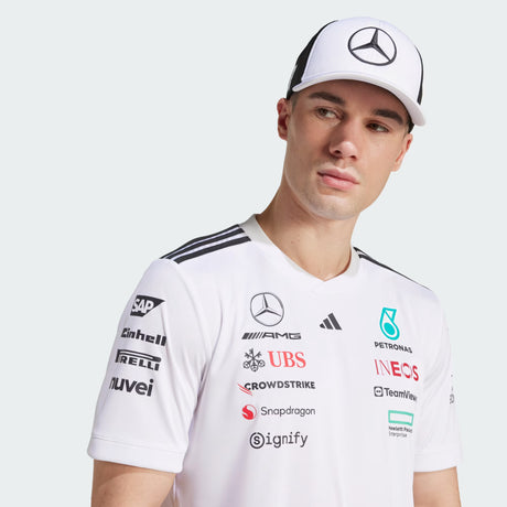 White T-shirt with Mercedes logo, cap worn backwards.