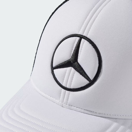 Detail of Mercedes cap in white fabric with black logo.