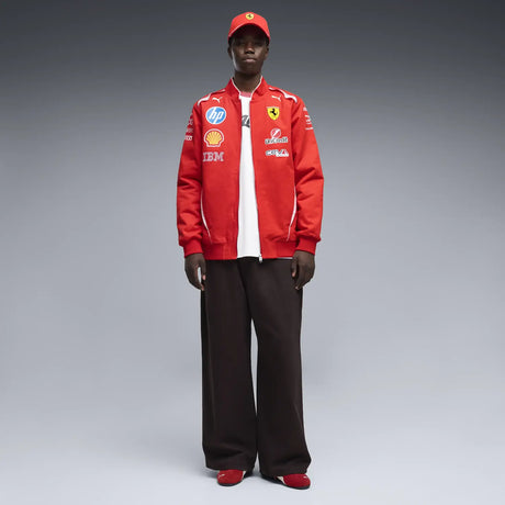Red Ferrari jacket worn by model with multiple logos.