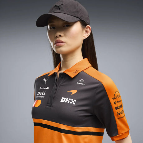 Woman wearing T-shirt and black cap with McLaren logo