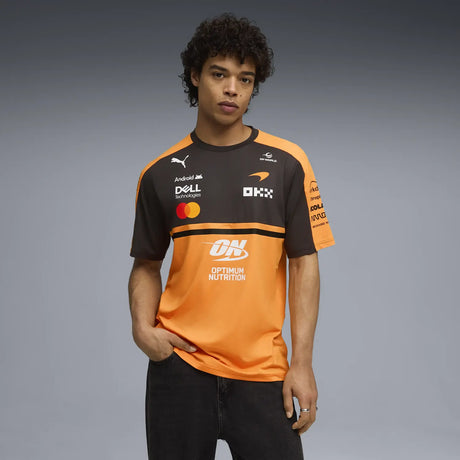 Black and orange t-shirt worn by male model with PUMA logo and lettering