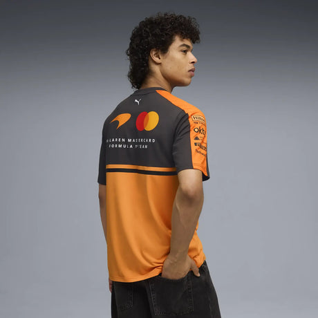 Black and orange t-shirt worn by male model with back lettering and PUMA logo