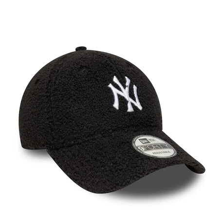 Black New Era cap with white NY logo side view.