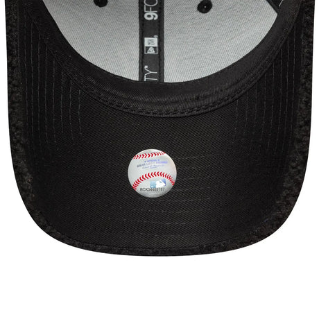 Inside view of black New Era cap with baseball emblem.