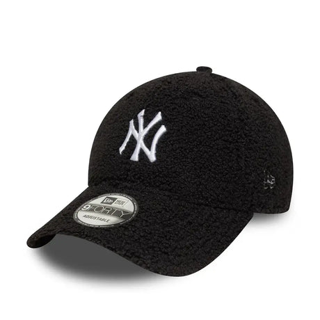 Black New Era cap with white NY logo side view.