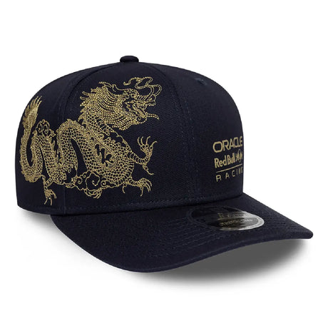 Blue baseball cap side view with gold dragon pattern.