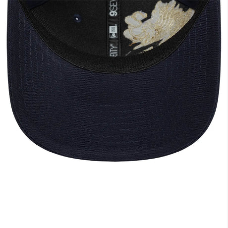 Inside view of blue baseball cap with gold dragon design.